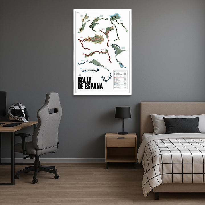 Room interior with a bed, desk, and chair, featuring a map of the 2019 Rally de Espana on the wall.