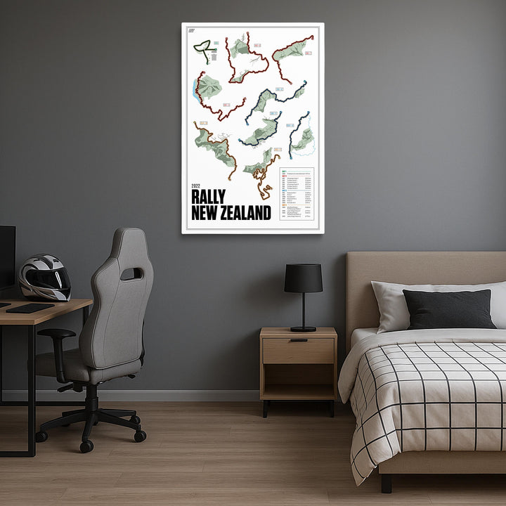 Room interior with a map of the 2022 Rally New Zealand on the wall, bed, desk, and chair.