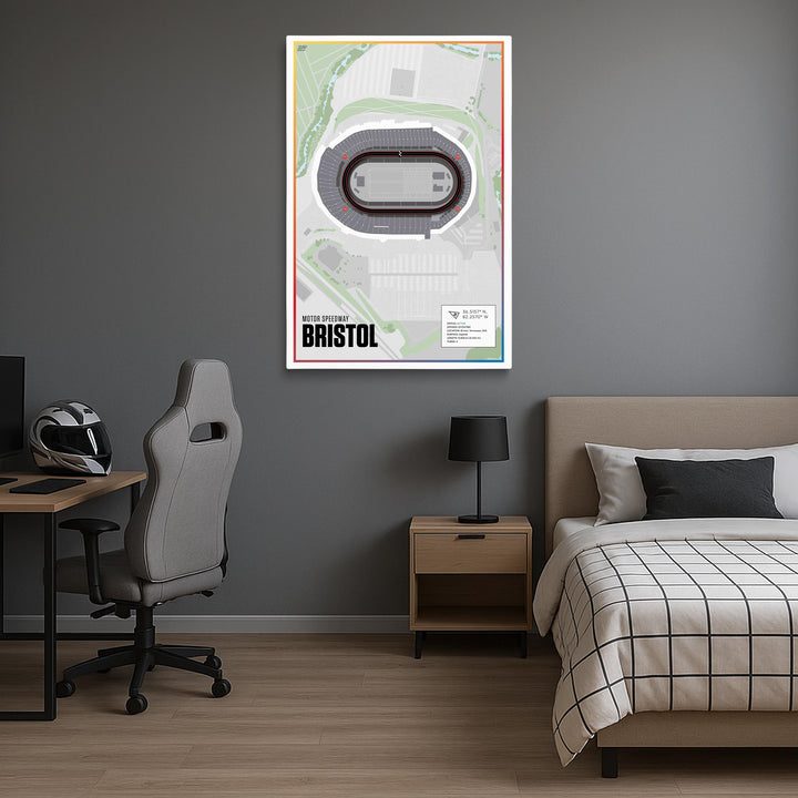 Room interior with a bed, desk, chair, and framed map of Bristol on the wall.