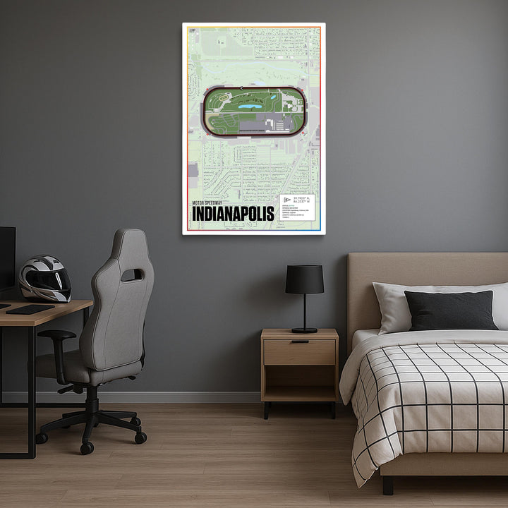 Room interior with a bed, desk, and chair against a gray wall with a framed map of Indianapolis.