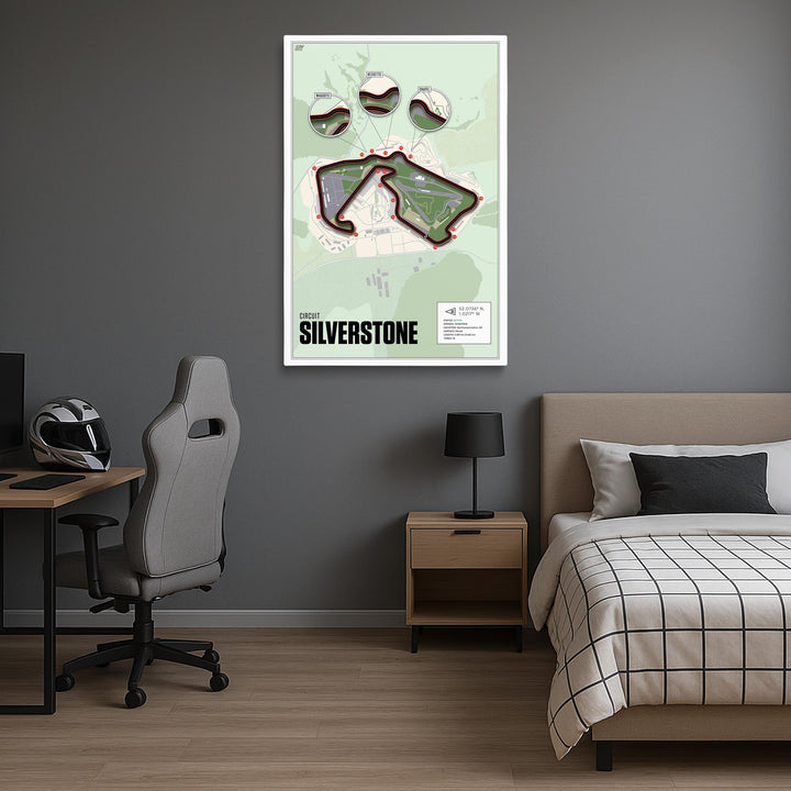 Room interior with a bed, desk, and wall art of Silverstone race track.