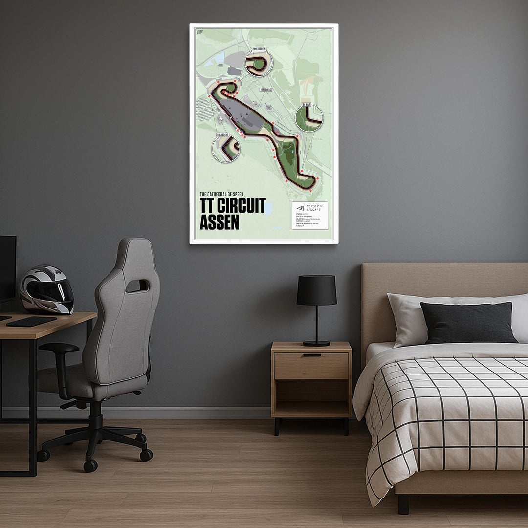 Room interior with a bed, desk, and chair, featuring a framed map of TT Circuit Assen on the wall.