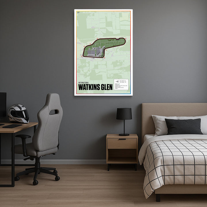 Room interior with a bed, desk, and chair, featuring a framed map of Watkins Glen on the wall.